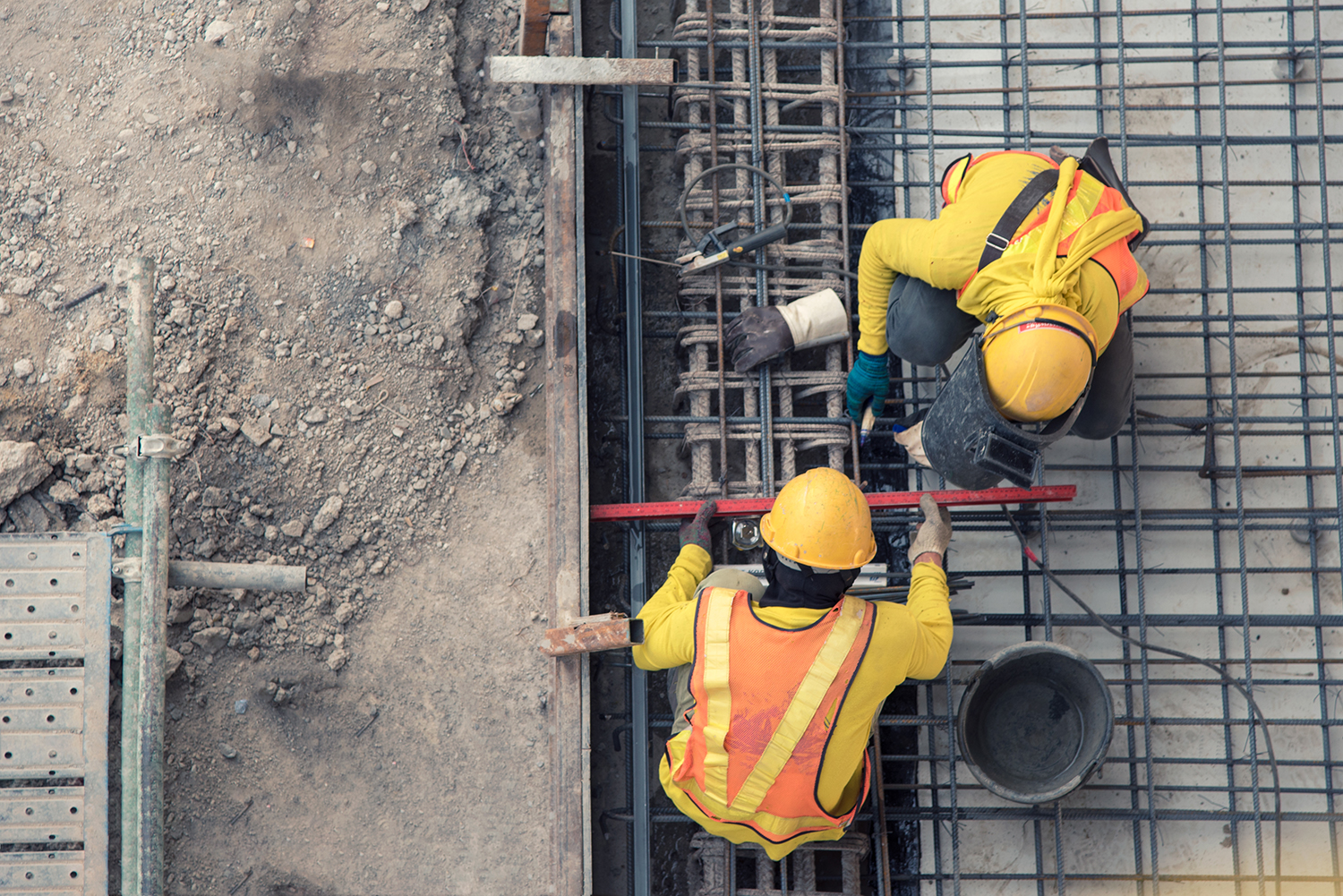 stock photo-aerial-view-of-construction-worker-in-construction-site-1006180303